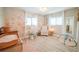 Charming Bedroom with floral wallpaper and light wood flooring offers a comforting and stylish space at 7234 Mamouth St, Englewood, FL 34224