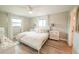 Bright bedroom with neutral walls, light wood flooring, and ample natural light from dual windows at 7234 Mamouth St, Englewood, FL 34224
