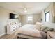 Comfortable bedroom featuring wood floors, soft décor and a large window providing plenty of natural light at 7234 Mamouth St, Englewood, FL 34224