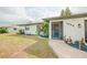 Charming single-story home featuring well-maintained landscaping, a screen door, and a welcoming walkway at 7234 Mamouth St, Englewood, FL 34224