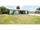Charming single-story home with a well-maintained front yard, featuring lush green grass and mature landscaping at 7234 Mamouth St, Englewood, FL 34224