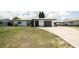 Single-story home with neat landscaping, a concrete driveway, and a one-car garage adding curb appeal at 7234 Mamouth St, Englewood, FL 34224