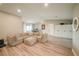 Spacious living room with comfortable seating, ceiling fan, and views of the front yard at 7234 Mamouth St, Englewood, FL 34224