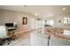 Comfortable living room featuring a sectional sofa, a ceiling fan and wood-look flooring at 7234 Mamouth St, Englewood, FL 34224