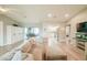 Open-concept living room with modern flooring and seamless transition to screened outdoor dining at 7234 Mamouth St, Englewood, FL 34224