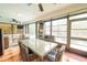 Bright sunroom with dining set and comfortable seating offers a relaxed indoor-outdoor living space at 7234 Mamouth St, Englewood, FL 34224