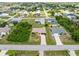 Single-story home in a tranquil residential neighborhood with lush greenery at 7393 Mamouth St, Englewood, FL 34224