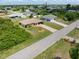 Single-story home with a long driveway, surrounded by mature landscaping at 7393 Mamouth St, Englewood, FL 34224