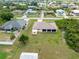 Overhead shot featuring a single-Gathering home with a well-kept lawn and a wooded area nearby at 7393 Mamouth St, Englewood, FL 34224