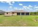 Large backyard with a storage shed, green lawn, and a bird bath, creating a serene outdoor space at 7393 Mamouth St, Englewood, FL 34224