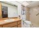 Updated bathroom featuring a vanity with wood cabinets and a walk-in shower at 7393 Mamouth St, Englewood, FL 34224