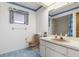 Bathroom with blue tile flooring, vanity with sink and mirror, a toilet, and a walk-in shower at 7393 Mamouth St, Englewood, FL 34224