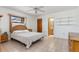 Cozy bedroom with a queen bed, neutral décor, and an en-suite bathroom at 7393 Mamouth St, Englewood, FL 34224