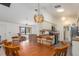 Inviting dining area with a wooden table, kitchen view, and ample natural light at 7393 Mamouth St, Englewood, FL 34224