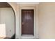 Close-up of a solid front door with detailed molding and secure hardware at 7393 Mamouth St, Englewood, FL 34224