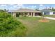 Inviting single-story home with a well-maintained lawn and mature landscaping at 7393 Mamouth St, Englewood, FL 34224