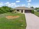 Charming single-story home featuring a well-manicured lawn and long driveway at 7393 Mamouth St, Englewood, FL 34224