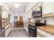 Bright kitchen featuring wood countertops, updated appliances, and a view to the dining area at 7393 Mamouth St, Englewood, FL 34224
