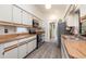 Clean kitchen with white cabinets, stainless steel appliances, and durable floors at 7393 Mamouth St, Englewood, FL 34224