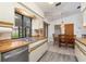 Bright kitchen featuring a stainless steel dishwasher and sink with a view to the dining area at 7393 Mamouth St, Englewood, FL 34224
