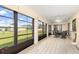 Spacious enclosed lanai with large windows offering a view of the yard and a comfortable seating area at 7393 Mamouth St, Englewood, FL 34224