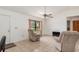 Cozy living room featuring tile flooring, neutral-toned recliners, and a large window at 7393 Mamouth St, Englewood, FL 34224