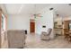 Inviting living room with tile flooring, neutral-toned recliners, and a ceiling fan at 7393 Mamouth St, Englewood, FL 34224