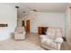 Open living room with tile floors, two comfortable recliners and a desk at 7393 Mamouth St, Englewood, FL 34224