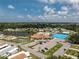 Scenic aerial showcasing the community's pool, tennis court, clubhouse, and lush landscaping at 867 Cascade Ct, Englewood, FL 34223