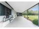 Covered front patio with an outside view, lawn, and shrubs at 867 Cascade Ct, Englewood, FL 34223