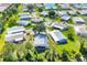 Beautiful aerial view of a well-maintained neighborhood with mature trees and lush landscaping at 878 Fawnspring Ct, Englewood, FL 34223