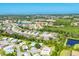 Expansive aerial shot showcasing a neighborhood near coastal waterways and lush greenery at 878 Fawnspring Ct, Englewood, FL 34223