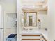 Bathroom featuring a vanity with light wood trim, white countertops, and a large mirror at 878 Fawnspring Ct, Englewood, FL 34223