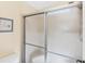 Bathroom showing a shower with sliding glass doors and a white toilet at 878 Fawnspring Ct, Englewood, FL 34223