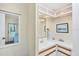 Well-lit bathroom with a white sink, vanity with cabinets, and a large mirror at 878 Fawnspring Ct, Englewood, FL 34223