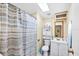 Bathroom featuring a shower with striped curtain, a toilet, and vanity with storage at 878 Fawnspring Ct, Englewood, FL 34223