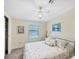 Comfortable bedroom with a ceiling fan, a closet and a seaside themed painting at 878 Fawnspring Ct, Englewood, FL 34223