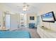 Cozy bedroom showcasing a view into the bathroom, a white dresser, and comfortable sleeping space at 878 Fawnspring Ct, Englewood, FL 34223