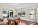 Cozy dining area with wood table, chairs and plenty of light with an adjacent doorway at 878 Fawnspring Ct, Englewood, FL 34223