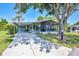Charming single-story home with a covered parking and inviting screened-in lanai at 878 Fawnspring Ct, Englewood, FL 34223