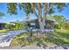 Well-maintained home boasts covered parking, a screened lanai, and mature landscaping at 878 Fawnspring Ct, Englewood, FL 34223