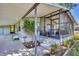 Welcoming covered front porch and screened in lanai of light grey residential home at 878 Fawnspring Ct, Englewood, FL 34223
