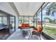 Screened-in porch features cozy seating, sliding glass doors and outdoor ambiance at 878 Fawnspring Ct, Englewood, FL 34223
