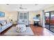 Bright living room with wood floors, neutral decor and easy access to lanai at 878 Fawnspring Ct, Englewood, FL 34223
