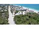 Gorgeous aerial view of the home and surrounding neighborhood near the sandy beach and the Gulf of Mexico at 95 Coquina Ln, Englewood, FL 34223