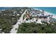 An aerial view shows the property near a road and beach at 95 Coquina Ln, Englewood, FL 34223