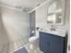 Newly remodeled bathroom with a sleek glass shower, modern vanity, and decorative tile floor at 95 Coquina Ln, Englewood, FL 34223