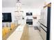 Lovely bright kitchen with white cabinets, stainless steel appliances, and adjacent dining area at 95 Coquina Ln, Englewood, FL 34223