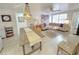 Cozy living room featuring a seashell chandelier, comfortable seating, and lots of natural light at 95 Coquina Ln, Englewood, FL 34223
