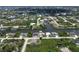Aerial view of the neighborhood showcasing waterways, homes, and trees at 10048 Winnipeg St, Port Charlotte, FL 33981